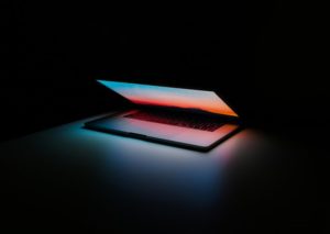 always on, technology, laptop open in dark room