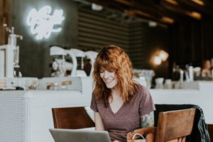 woman on laptop speaking with online community